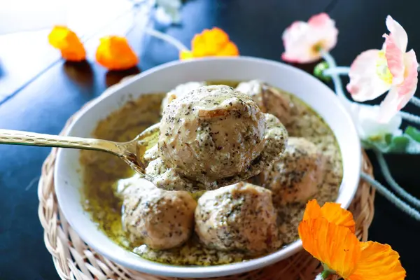 Hand-beaten Gushtaba meatballs in yogurt gravy